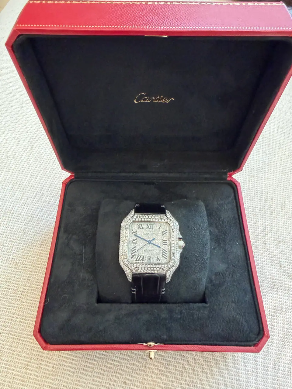 Cartier Santos watch in its open red Cartier box